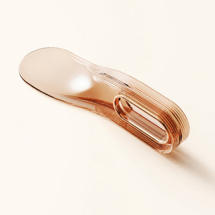Translucent orange Tuckora mattress lifter on a warm ivory background