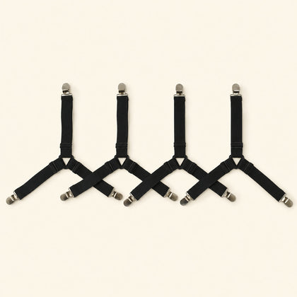 Four adjustable black fitted-sheet corner straps with metal clips