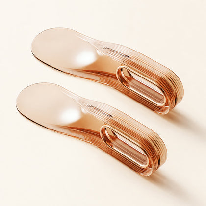 Two translucent amber Tuckora mattress lifters on an ivory background