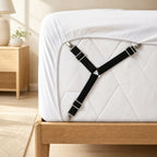 Black fitted-sheet strap attached beneath a mattress corner