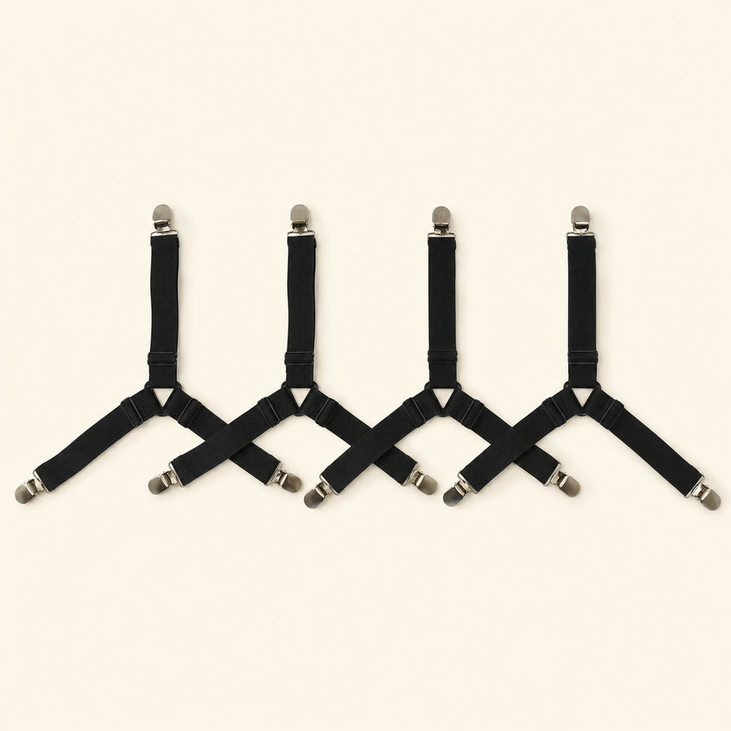 Four adjustable black fitted-sheet corner straps with metal clips