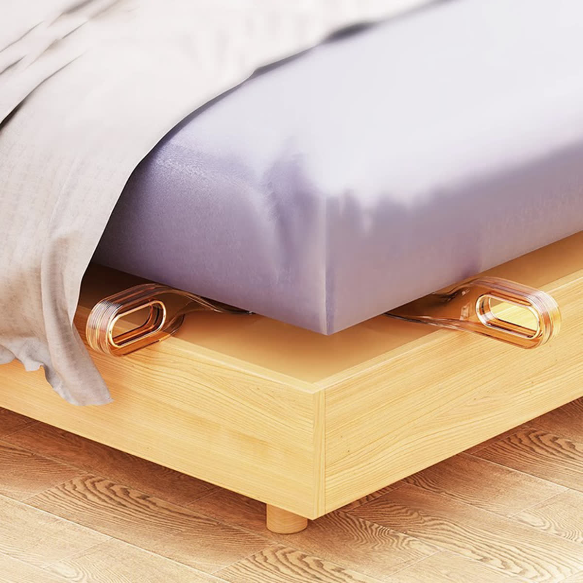 Two amber mattress lifters beneath a mattress edge
